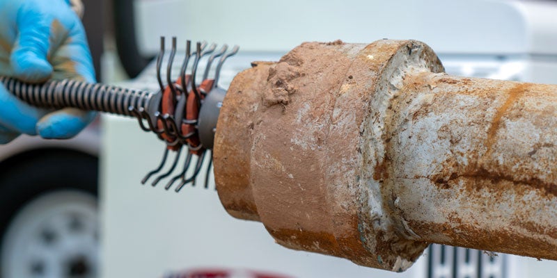 Descaling tools being used on pipe